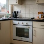 a slightly neglected home oven in a modest middle-class kitchen in Croydon, South London